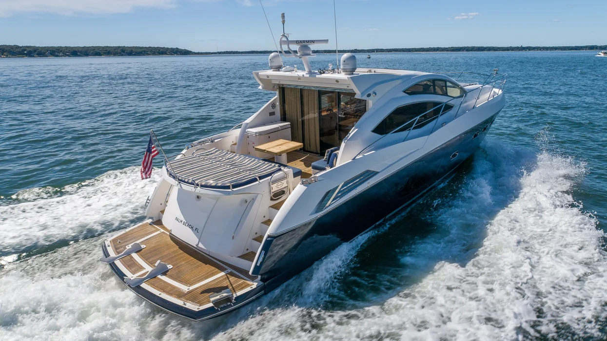 Luxury motor yacht cruising with spacious aft deck seating.