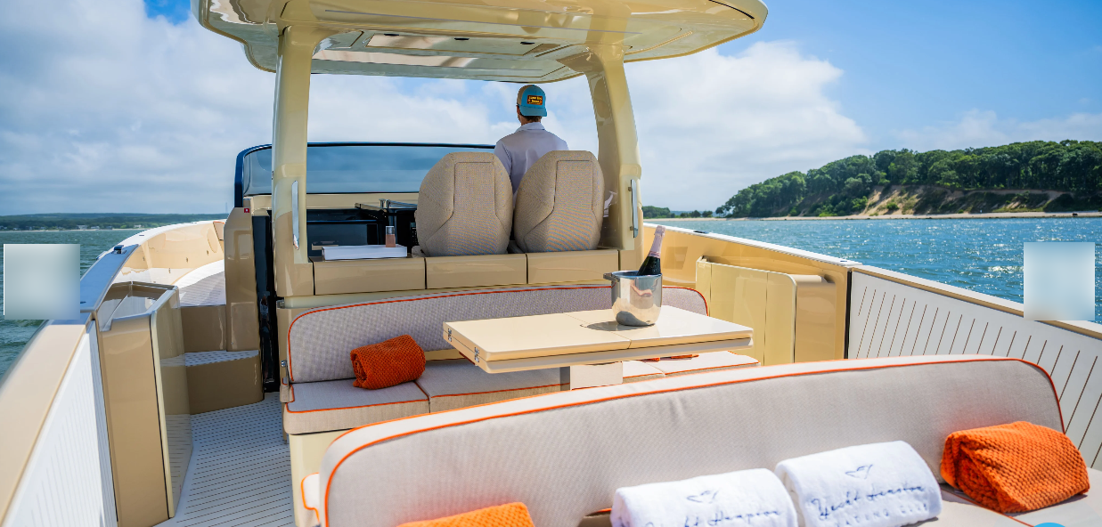 Private boat charter cruises past forested shoreline on a sunny day.