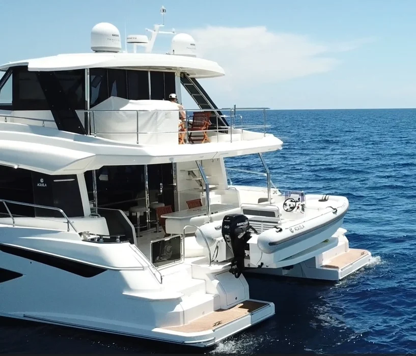 Luxury yacht with tender on open sea.