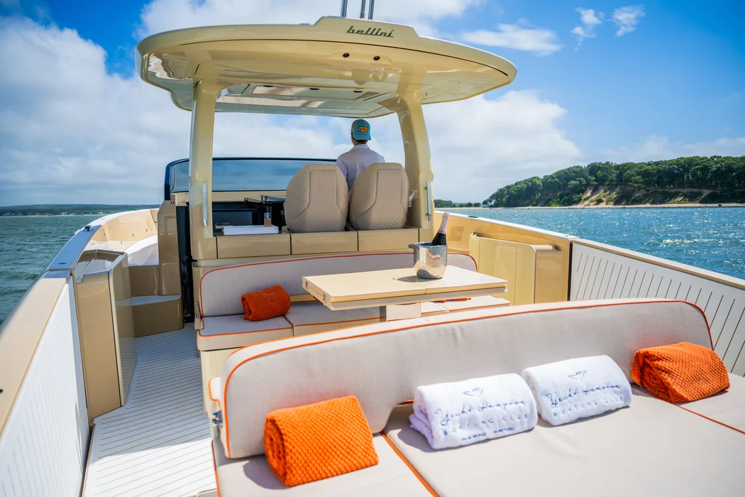 Luxury private yacht rental with champagne and scenic shoreline.