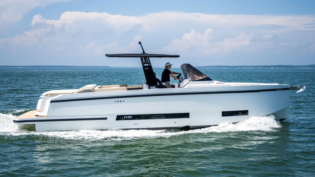 Modern private yacht rental cruising on calm ocean waters.