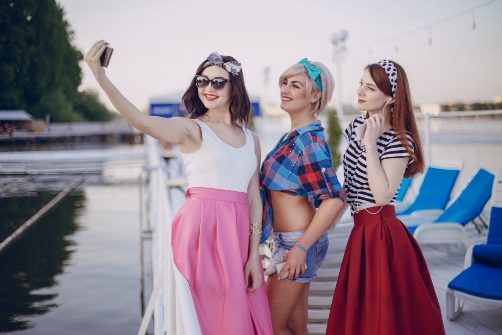  Young girls clicking pictures on a bachelorette party 