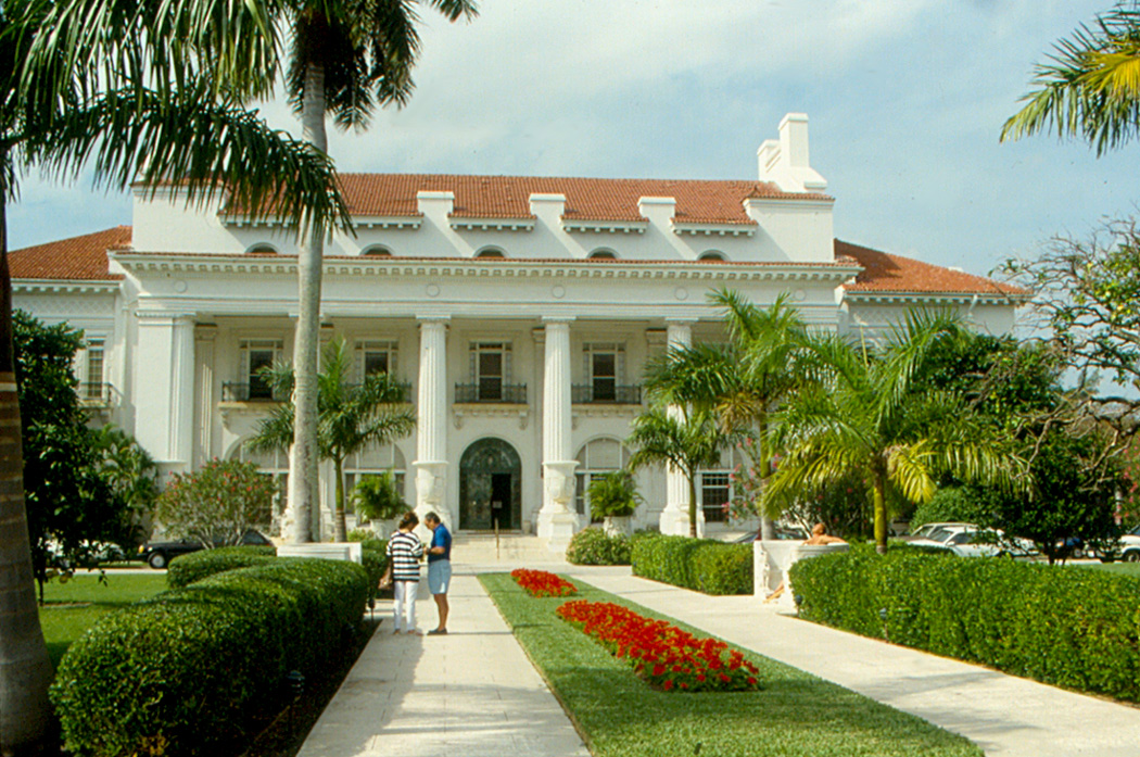 Whitehall Flagler Museum mansion with palm trees and gardens.