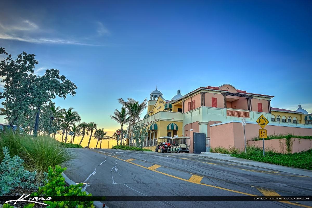 Lake Worth Casino building with domes, palms, and sunset.