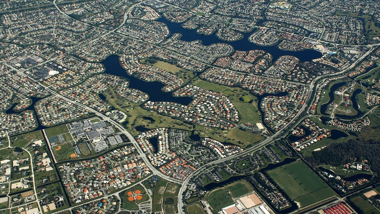 Wellington Beach Florida suburban neighborhoods with winding canals aerial. 