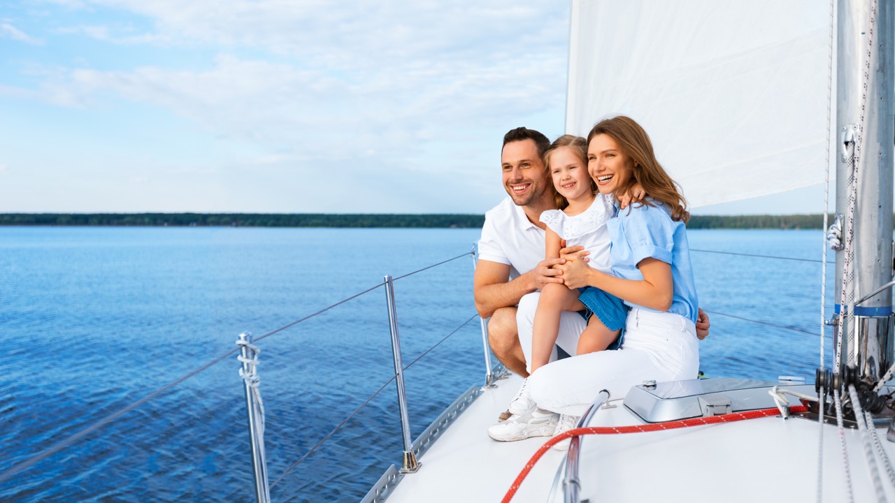 family-sailing-in-sea-sitting-on-sailboat-deck-out-2022-12-16-06-43-26-utc Large