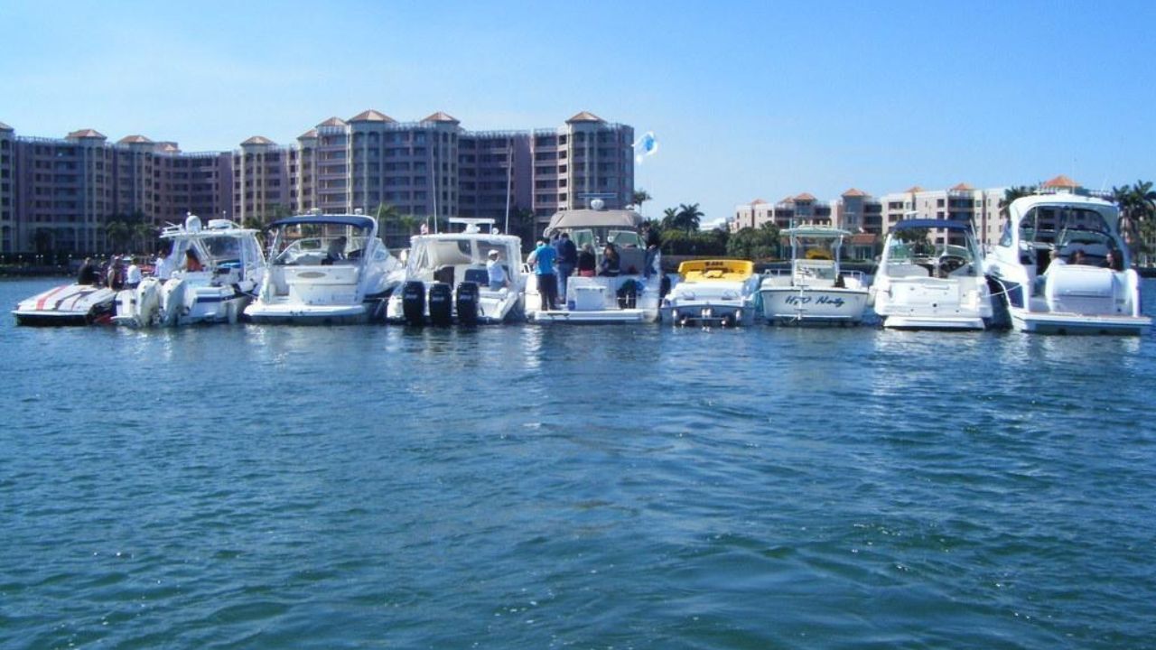 Boats anchored near waterfront buildings at Lake Boca Sandbar